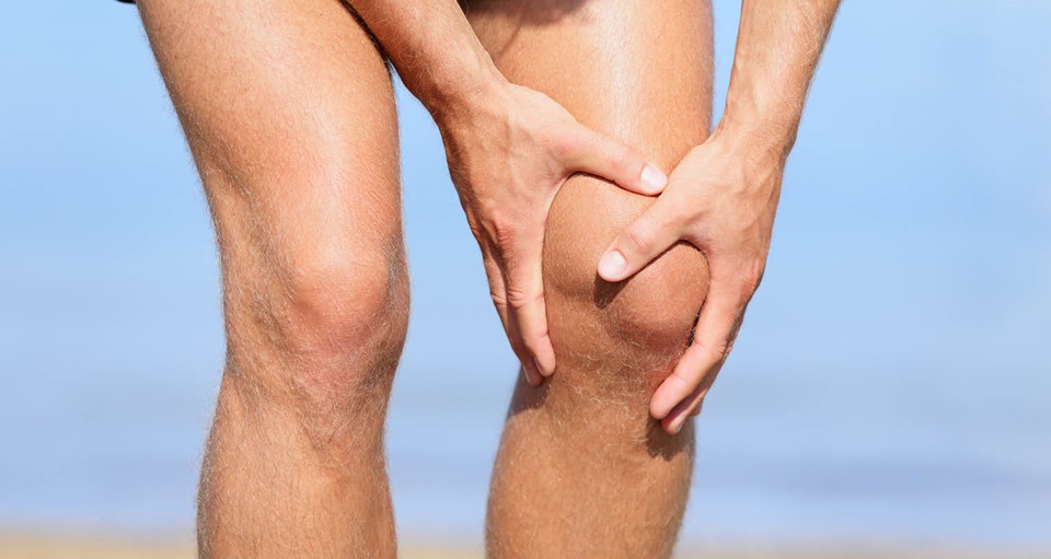 person holding their sore knee