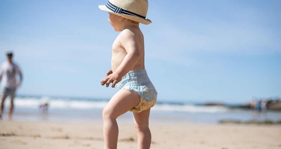 baby walking on beach