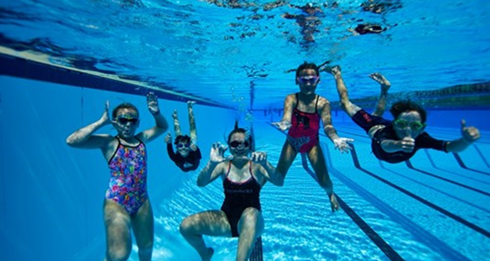 Group of happy kids swimming underwater